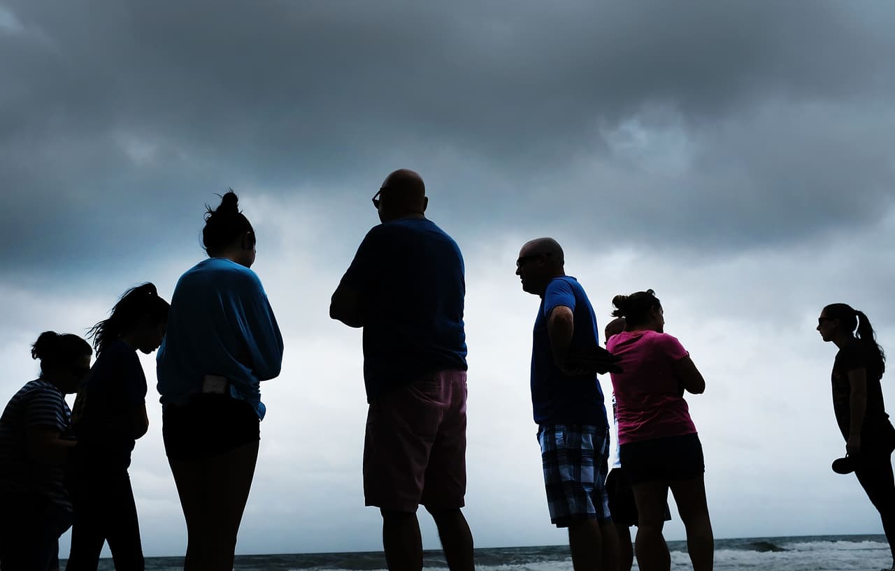 People gathered on Naples beach before the arrival of the hurricane, Sept 9. The area has already begun to be whipped for strong winds which are forecast to intensify on Sunday.