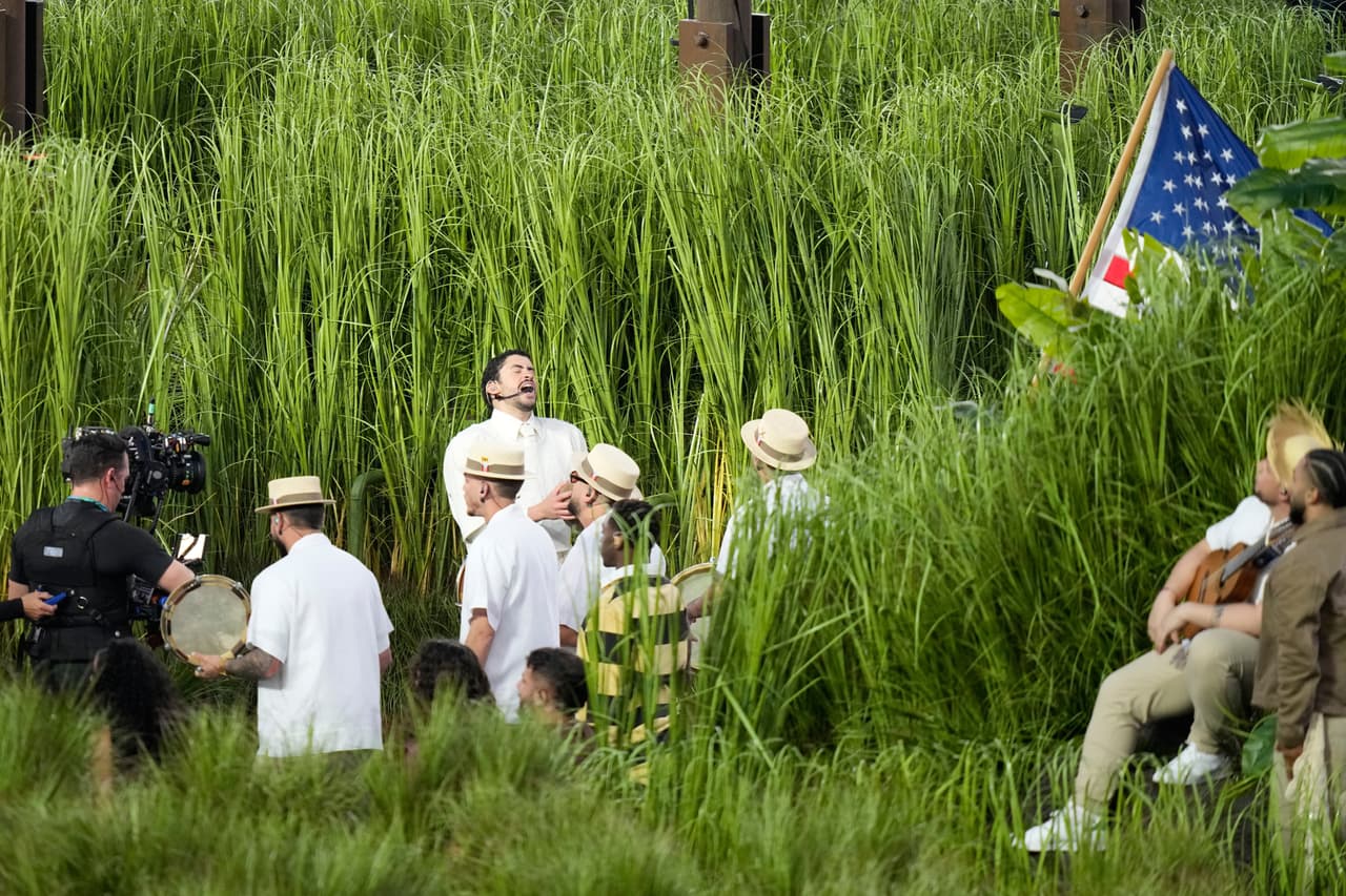 El sol ya estaba bajo en el estadio cuando apareció en los cañaverales de Puerto Rico durante su espectáculo, rodeado de jíbaros con pavas (campesinos con sombreros de paja tradicionales), adultos mayores jugando dominó y un puesto de piragua (hielo raspado), símbolos innegables de Puerto Rico.