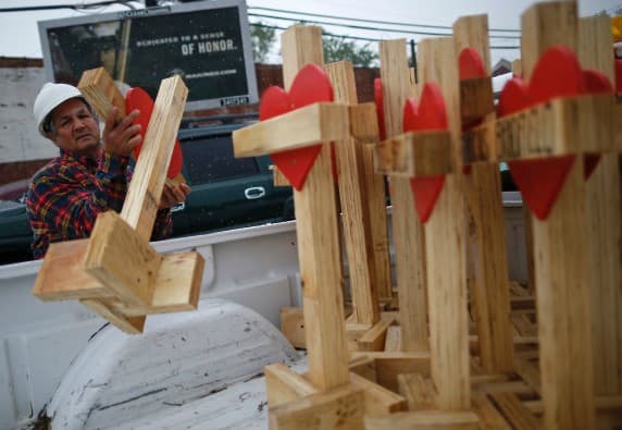 El carpintero Greg Zanis bajando cruces de su camioneta en una vigilia sobre la violencia en Chicago