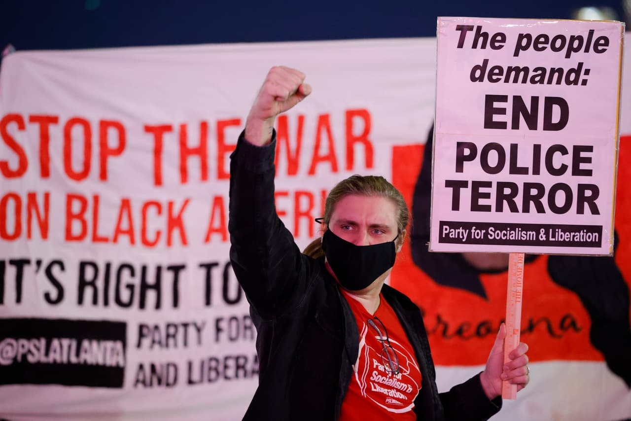 A demonstrator gestures at a gathering during a protest over the death of Tyre Nichols, Friday, Jan. 27, 2023, in Atlanta. (AP Photo/Alex Slitz)