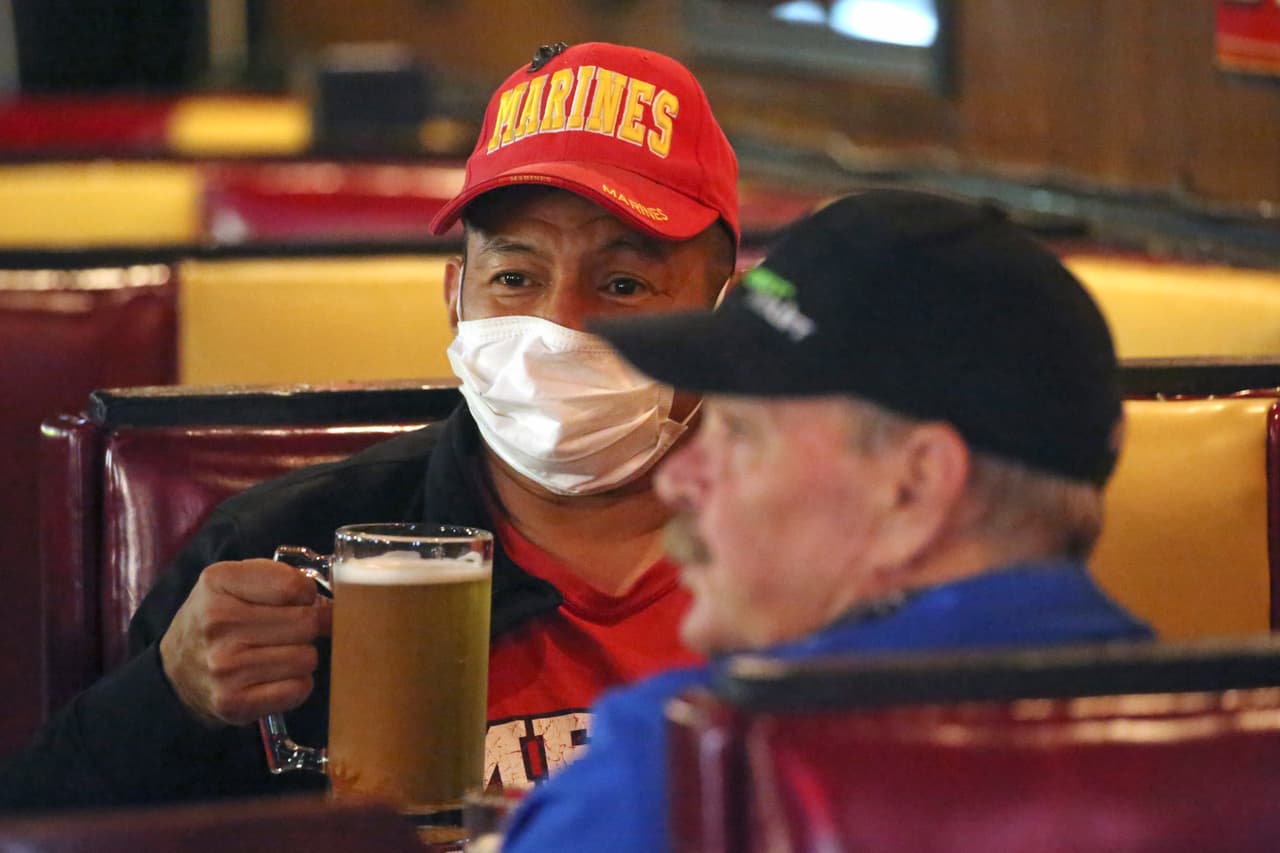 En Utah, el gobernador Gary R. Herbert, republicano, permitió que los restaurantes, zoológicos, gimnasios y salones de belleza reabrieran con precauciones a partir del 1 de mayo. En la fotografía, clientes protegidos con máscaras en un bar de Salt Lake City.