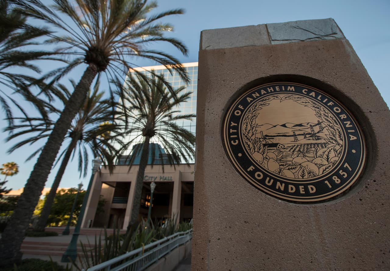 3- 
<b>Anaheim, California:</b> Comparte el tercer puesto entre las ciudades con mayores costos de vida, con una diferencia significativa entre los ingresos necesarios y los salarios promedio. Para un adulto, alcanzar una estabilidad económica requiere alrededor de 151,965 dólares al año, mientras que una familia de cuatro personas necesita aproximadamente 327,226 dólares. En contraste, el ingreso medio de los hogares se sitúa en 101,145 dólares, lo que evidencia el reto financiero que representa vivir en esta ciudad.