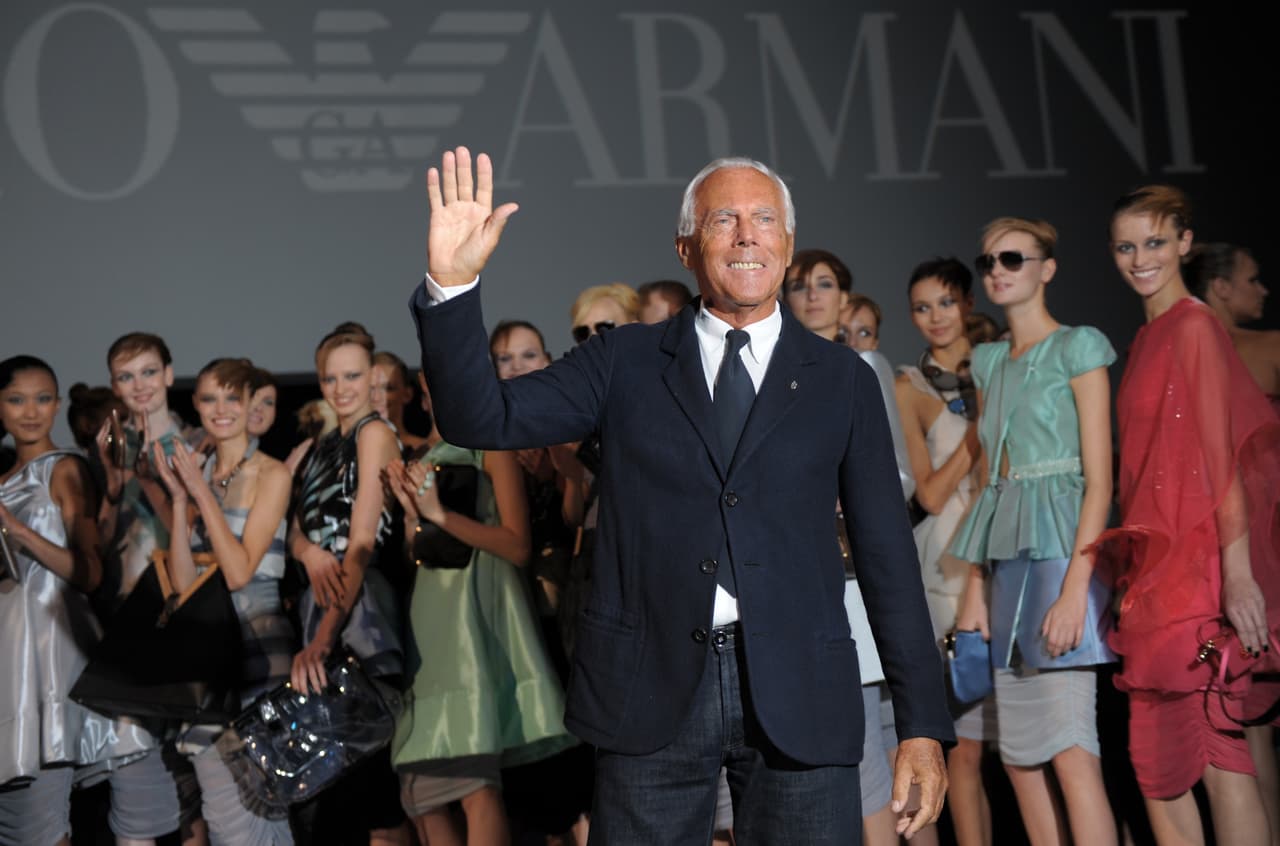 Italian fashion designer Giorgio Armani (C) poses with models forllowing the Emporio Armani spring-summer 2011 ready-to-wear collection on September 25, 2010 during the Women's fashion week in Milan. AFP PHOTO / GIUSEPPE CACACE (Photo credit should read GIUSEPPE CACACE/AFP via Getty Images)