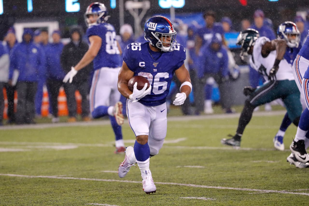 <b>Saquon Barkley | RB | New York Giants</b>
<br>
<b>- Edad: 23 años</b>
<br>- Ezekiel Elliott, Alvin Kamara y Dalvin Cook cumplen 25 años este verano. 
<br>- Barkley tiene un caso contra cualquiera como un monstruo de doble amenaza.
<br>- Deambula como un gran peligro en el juego aéreo con una jugosa línea 143 acarreos, 1,159 yardas y 6 touchdowns durante dos temporadas. 
<br>- Después de un esfuerzo de segundo año con sombra de lesiones, Barkley debería brillar en los próximos años como una maravilla eléctrica y resbaladiza en el campo de Nueva York.