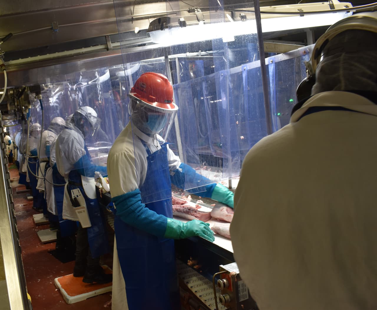 The production line at Tyson's Columbus Junction plant now has plexiglass dividers to protect workers.