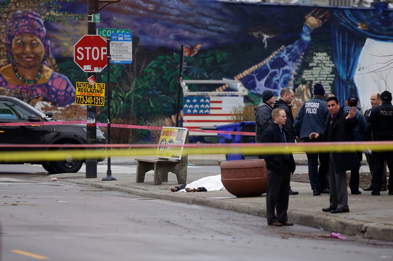 CHICAGO, IL - MARCH 30 : A body is covered with a white sheet as Chicago Police officers investigate the scene where four people were shot and killed at a restaurant in the 2700 block of East 75th Street on March 30, 2017 in Chicago, Illinois. A second shooting took place less then 2 miles away where a pregnant woman shot and killed. (Photo by Joshua Lott/Getty Images)