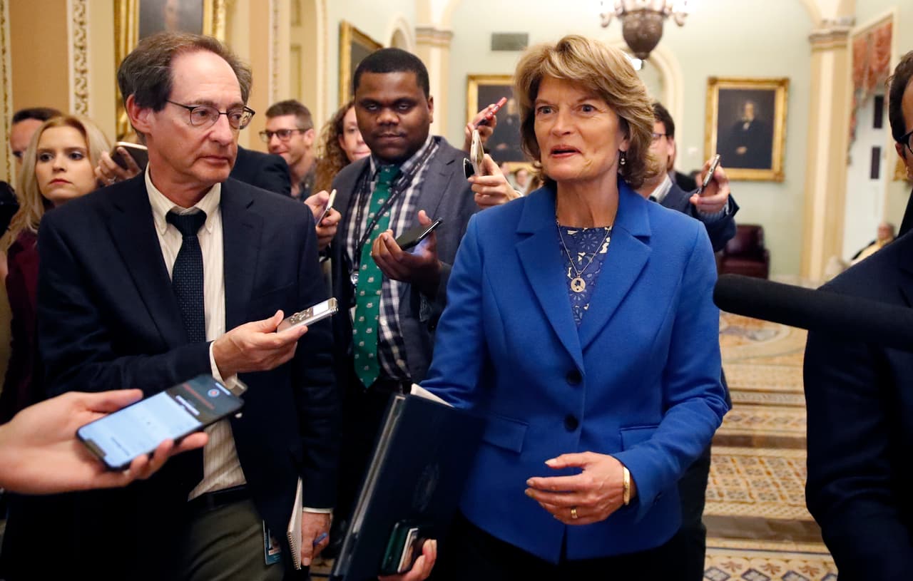 Sen. Lisa Murkowski, R-Alaska, right, walks with journalists as she departs the Republican policy luncheon, on Capitol Hill, Tuesday, Sept. 25, 2018 in Washington. (AP Photo/Alex Brandon)