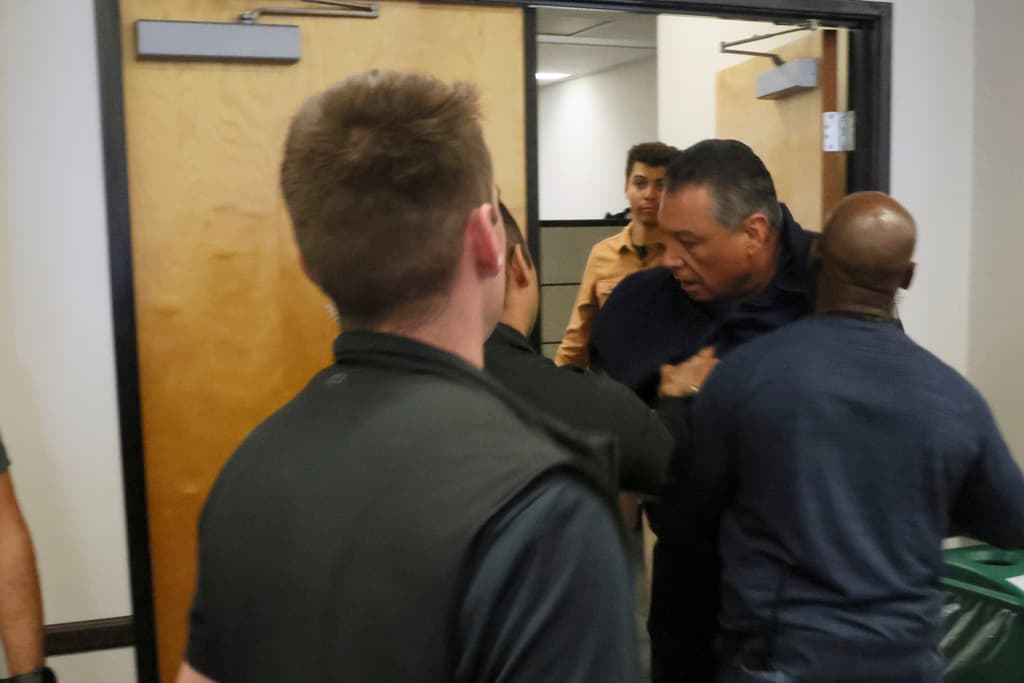 U.S. Sen. Alex Padilla is pushed out of the room as Homeland Security Secretary Kristi Noem holds a news conference regarding the recent protests in Los Angeles on Thursday, June 12, 2025. (AP Photo/Etienne Laurent)