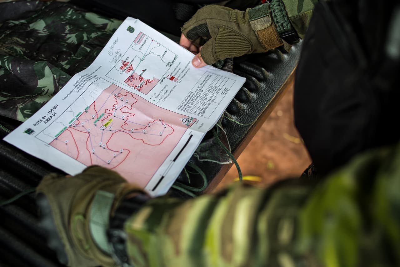 One of the agents studies the area where the day’s mission will take place.