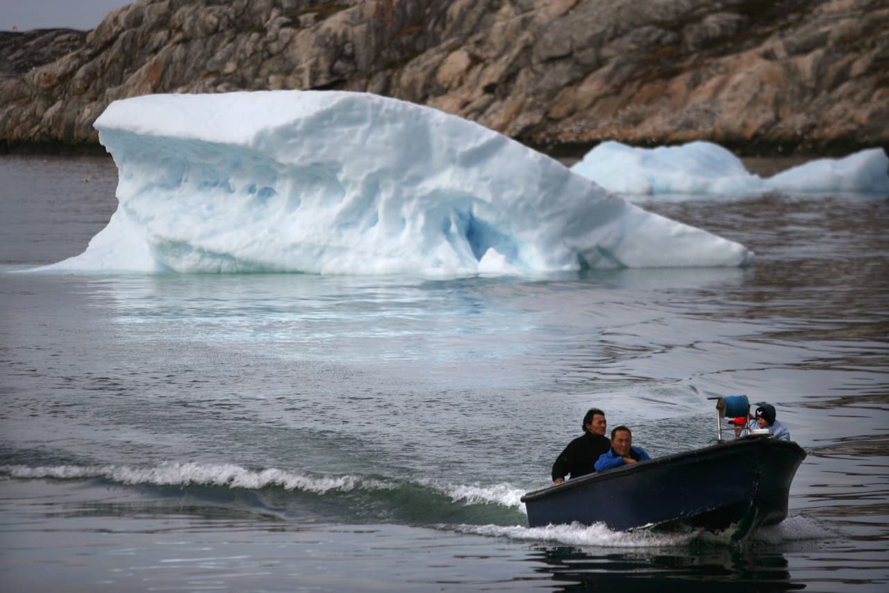 ILULISSAT, GREENLAND - AUGUST 30: (ISRAEL OUT) Inuit fishermen sail in their boat August 30, 2007, in the town of Ilulissat Greenland. Even though the disappearing ice cap could lead to higher sea levels all over the world, Greenland's Inuit population are the first to feel the effects of global warming. Records show that the average air temperature has risen by four degrees Celsius over the past decade while the water temperature has climbed by two degrees. Fishermen and hunters avoid the fjords where the ice has become too thin to travel on, and fish such as cod, that prefer warmer water, are beginning to be seen in their nets. (Photo by Uriel Sinai/Getty Images)