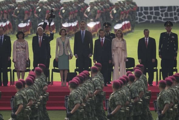 Los mandatarios observan la marcha de la tropas armadas en honor a los reyes.