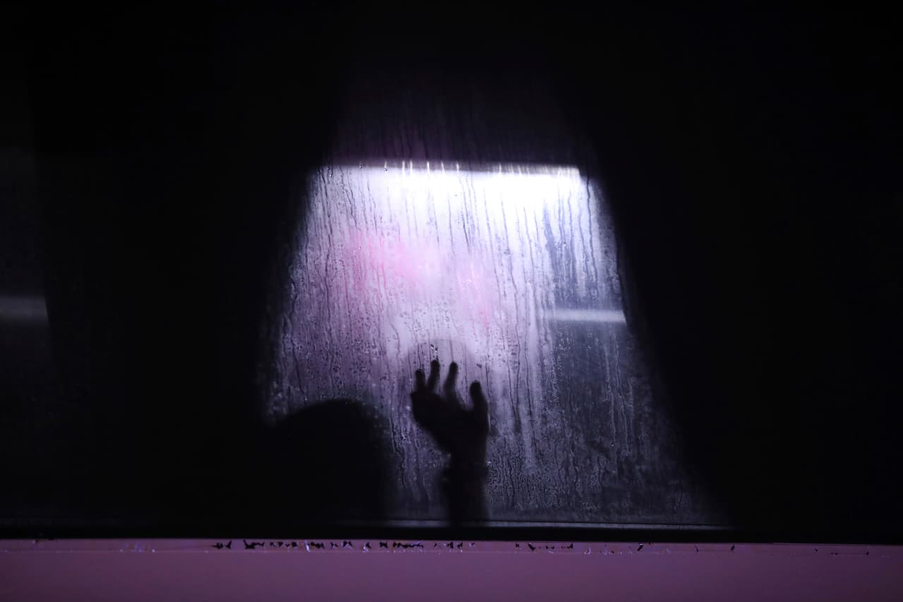 En esta foto del 15 de noviembre de 2019, un migrante pone su mano sobre la ventana de un autobús en Alvarado, en el estado mexicano de Veracruz. El migrante fue uno de algunas docenas de personas rescatadas por la policía después de ser secuestrados cuando viajaban hacia el norte del país. (AP Foto/Félix Márquez)