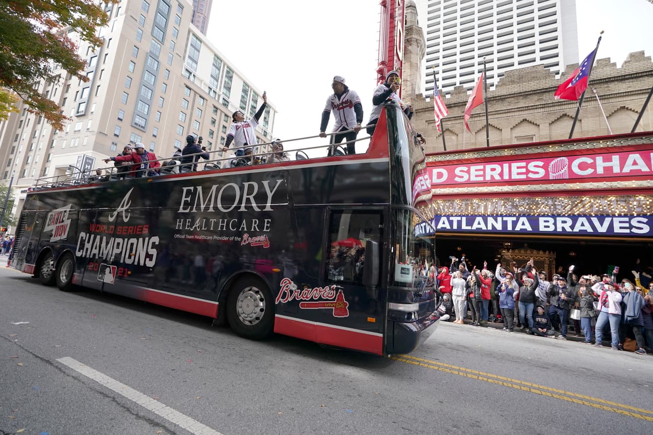 Atlanta Braves players celebrate the team's victory during a victory parade, Friday, Nov. 5, 2021, in Atlanta. The Braves beat the Houston Astros 7-0 in Game 6 on Tuesday to win their first World Series baseball title in 26 years. (AP Photo/Brynn Anderson)