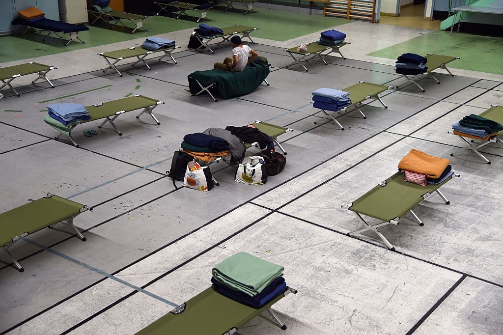 Camp beds and bedding are set-up in a gymnasium in Paris, on December 28, 2014, where the city's homeless can spend the night as winter temperatures drop across Europe. Heavy snowfall brought both chaos and joy across Europe, with some 15,000 people stranded overnight in the French Alps while skiers revelled in the fresh powder blanketing slopes. AFP PHOTO / DOMINIQUE FAGET (Photo credit should read DOMINIQUE FAGET/AFP/Getty Images)
