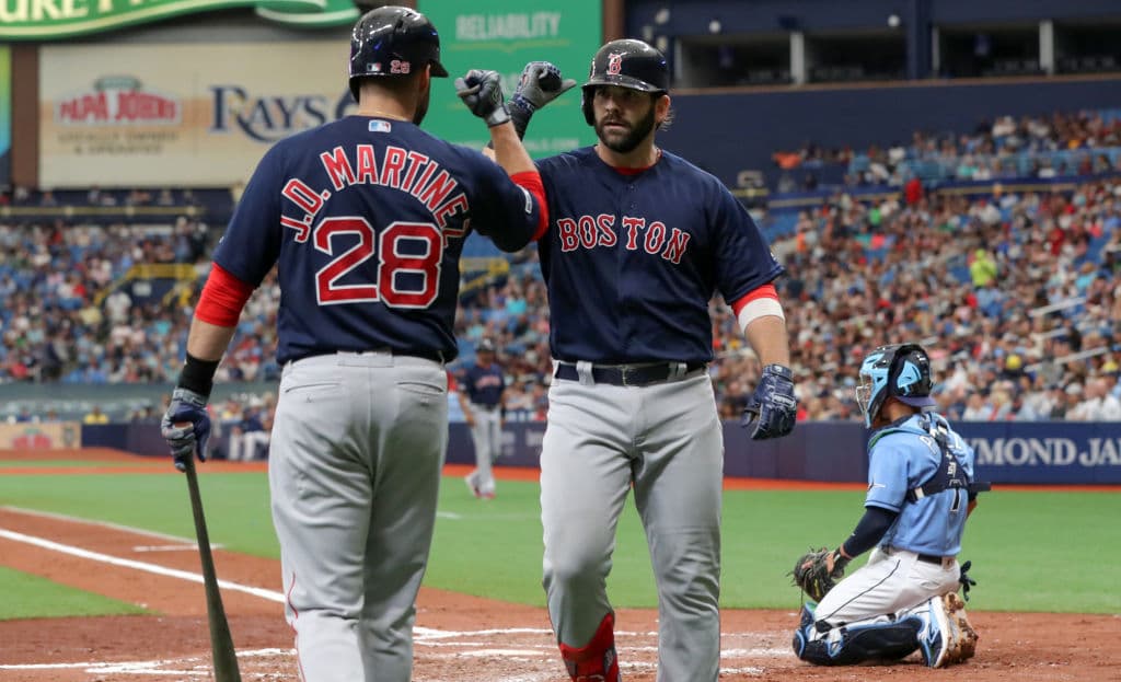 JD Martínez felicita a su compañero Mitch Moreland en la cuarta entrada luego de que el primera base de Boston conectara un jonrón que puso 2-1 la pizarra en favor de los visitantes.