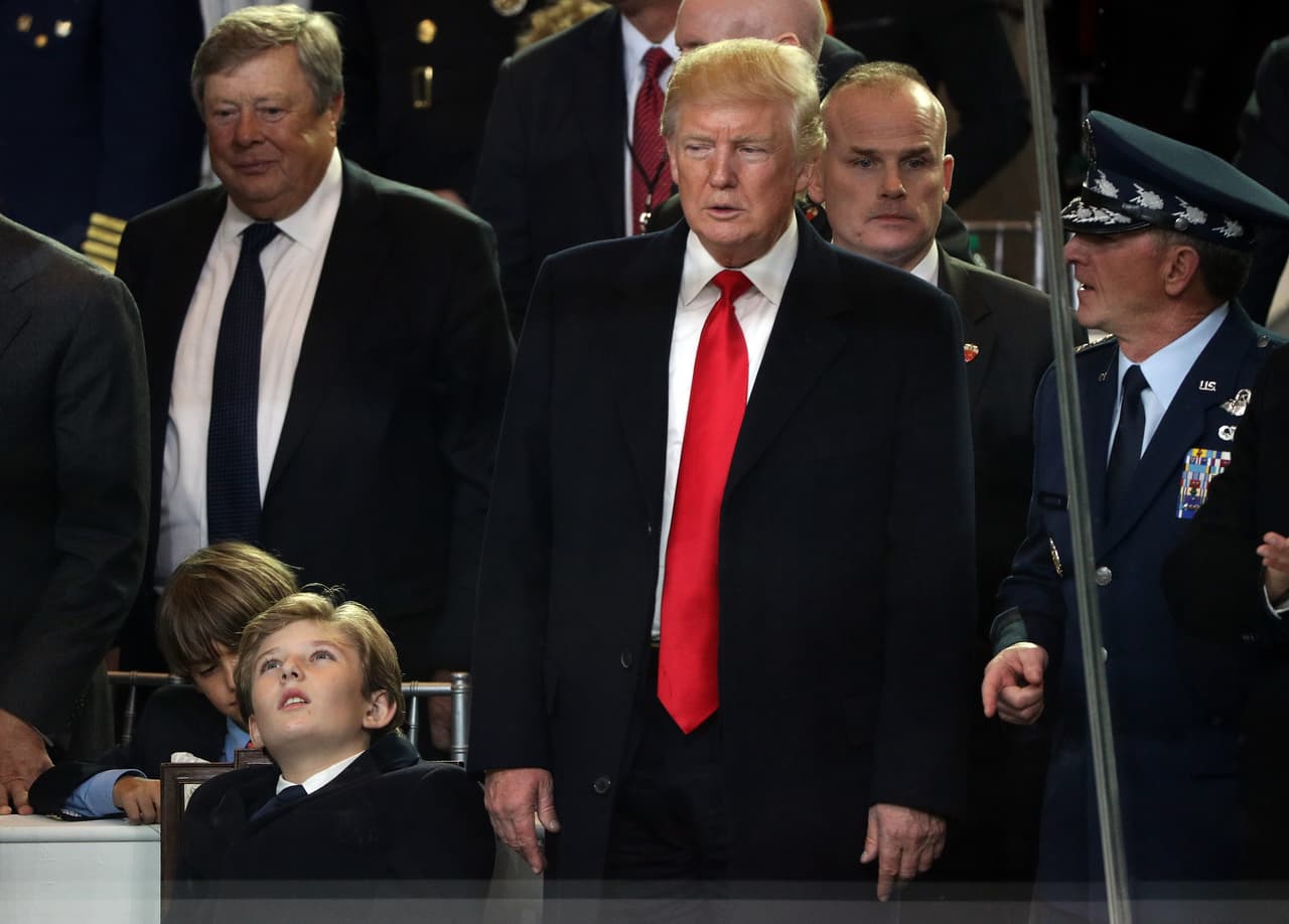WASHINGTON, DC - JANUARY 20: U.S. President Donald Trump (R) and Barron Trump watch the Inaugural Parade from the main reviewing stand in front of the White House on January 20, 2017 in Washington, DC. Donald J. Trump was sworn in today as the 45th president of the United States. (Photo by Patrick Smith/Getty Images)
