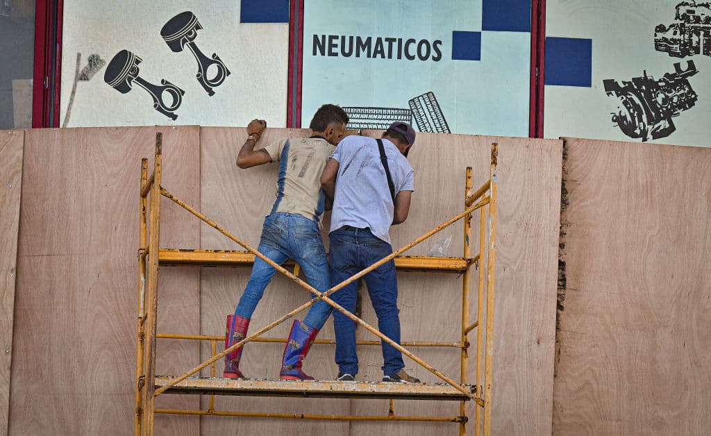 Los vientos del huracán Rafael podrían romper esos paneles, pero estos cubanos en La Habana buscaban la forma de colocarlos de manera que no se le hiciera fácil.