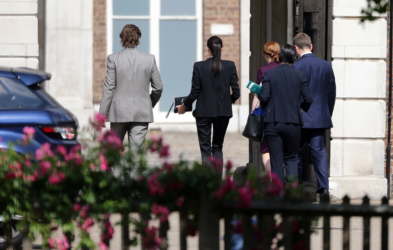 Uno de los asistentes de la pareja cargaba el paquete envuelto en papel azul.