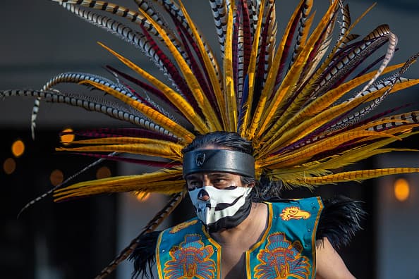 LOS ANGELES, CA - MAY 01: An Aztec dancer participates in a march on May Day, also known as International Workers Day, on May 1, 2019 in Los Angeles, California. People are participating in multiple May Day marches and rallies around Los Angeles, calling for support of labor and immigrant concerns such as wage improvement, immigration reform and a citizenship question in the upcoming national census. (Photo by David McNew/Getty Images)