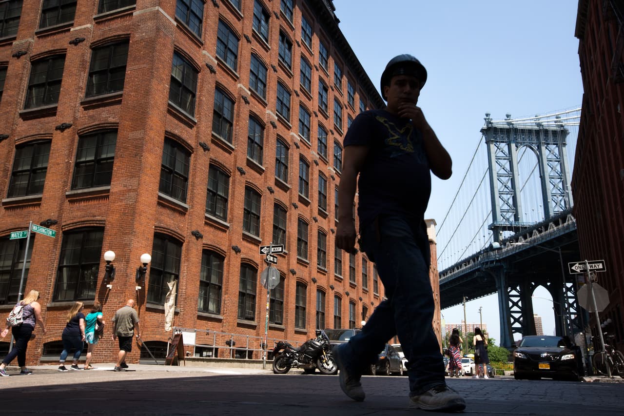 NEW YORK, NY - JUNE 24: People walk through an intersection in the DUMBO neighborhood on June 24, 2016 in the Brooklyn borough of New York City. According to a survey released on Thursday by real-estate firm RealtyTrac, Brooklyn ranked as the most unaffordable place to live in the United States. (Photo by Drew Angerer/Getty Images)