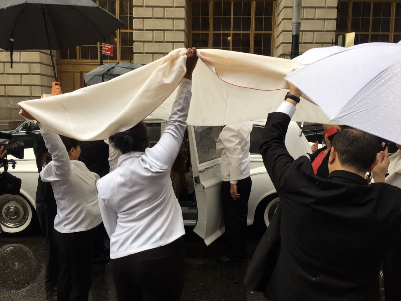 Sombrillas y telas blancas sirvieron para evitar que la novia se mojara, ya que después de la sesión de fotos y antes de la ceremonia, llovió en la ciudad de Nueva York.