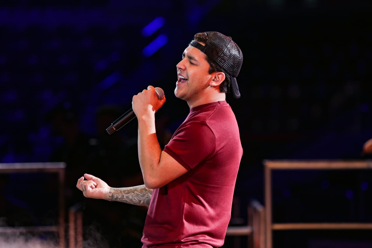 Un pantalón negro y una camiseta color vino así como una gorra negra.