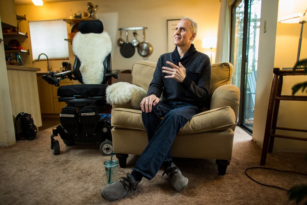 Aaron McQ speaks during an interview in his Seattle apartment on Jan. 31, 2018. McQ had been battling leukemia and a rare form of amyotrophic lateral sclerosis, or ALS, for five years. In November, doctors gave him six months or less to live and confirmed that he qualified to use Washington state’s aid-in-dying law. McQ filled the prescription for lethal drugs in late December, planning to use them within the next several weeks. The hard part, he said, was deciding exactly when to die. (Dan DeLong for KHN)