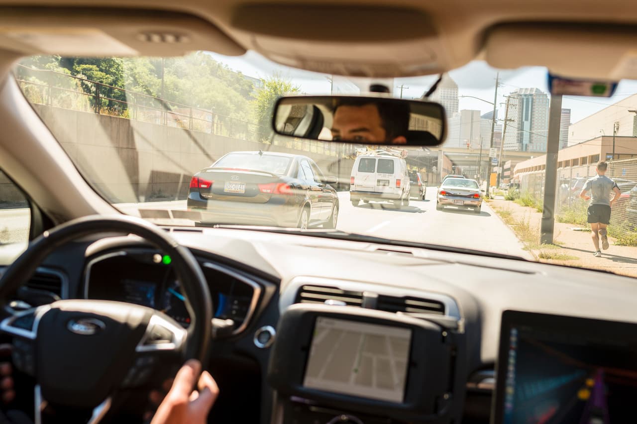 A driver looks from an Uber self-driving car on September 13, 2016 in Pittsburgh, Pennsylvania. Uber launched a groundbreaking driverless car service, stealing ahead of Detroit auto giants and Silicon Valley rivals with technology that could revolutionize transportation. / AFP / Angelo Merendino (Photo credit should read ANGELO MERENDINO/AFP/Getty Images)