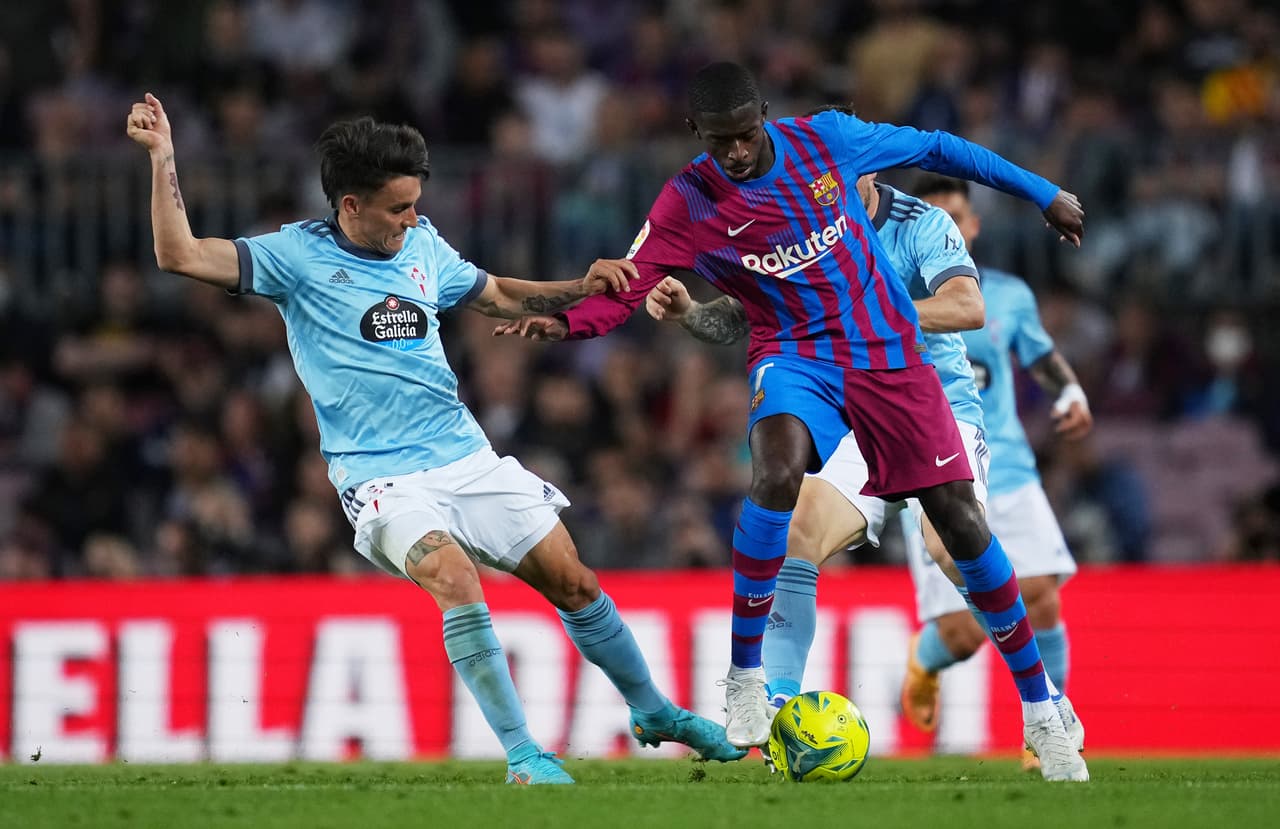 BARCELONA, SPAIN - MAY 10: Ousmane Dembele of FC Barcelona is challenged by Franco Cervi of RC Celta de Vigo during the La Liga Santander match between FC Barcelona and RC Celta de Vigo at Camp Nou on May 10, 2022 in Barcelona, Spain. (Photo by Alex Caparros/Getty Images)