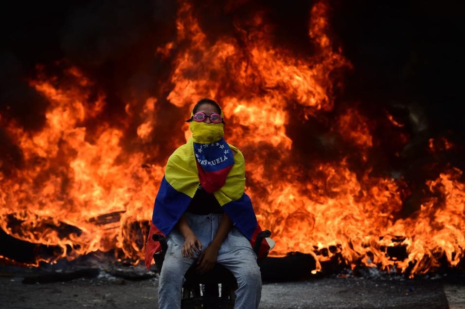 Swimming goggles are also a common sight on masked protesters, as well as the Venezuelan flag.