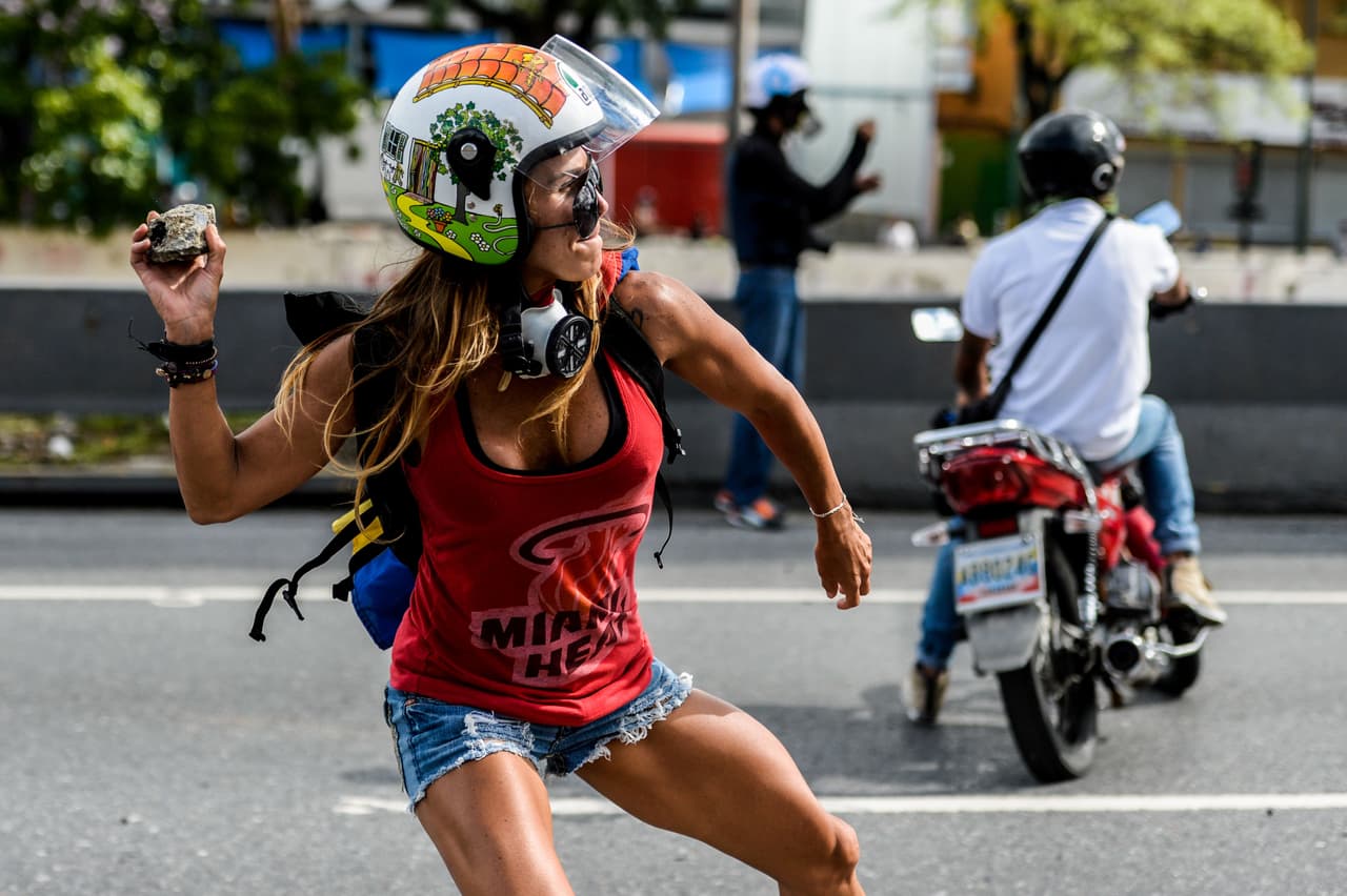 This photo of a protester, Caterina Ciarceluti, throwing rocks at police on May 1, 2017, was published all around the world.