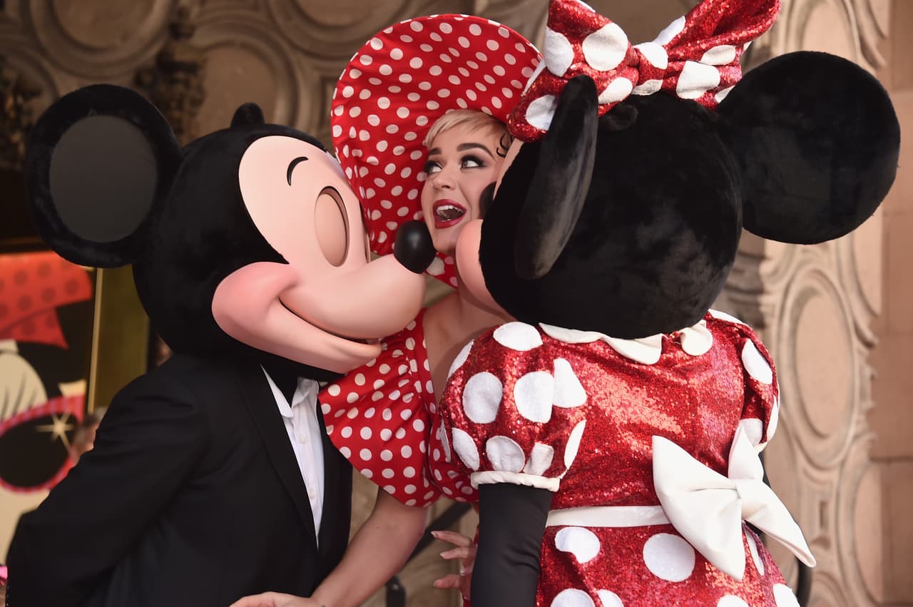 HOLLYWOOD, CA - JANUARY 22: Singer Katy Perry (C) stands on stage next to Mickey Mouse and Minnie Mouse during a star ceremony in celebration of the 90th anniversary of Disney's Minnie Mouse at the Hollywood Walk of Fame on January 22, 2018 in Hollywood, California. (Photo by Alberto E. Rodriguez/Getty Images)