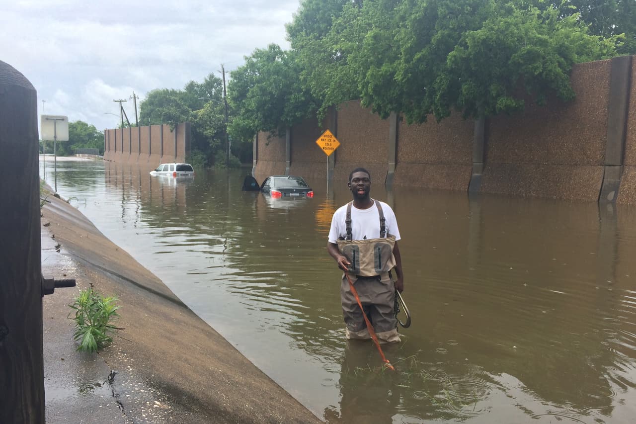 Un obrero trata de descongestionar uno de los desagües en la calle South Loop West, en el sector de Meyerland, al suroeste de la ciudad.