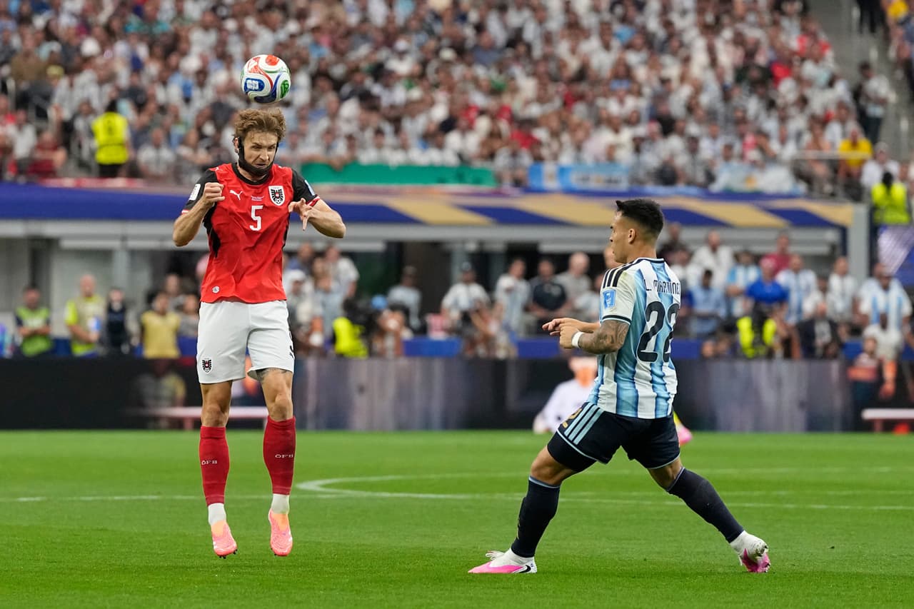 Austria's Stefan Posch (5) heads the ball as Argentina's Lautaro Martinez (22) looks on during the World Cup Group J soccer match between Argentina and Austria in Arlington, Texas, near Dallas, Monday, June 22, 2026. (AP Photo/Ashley Landis)
