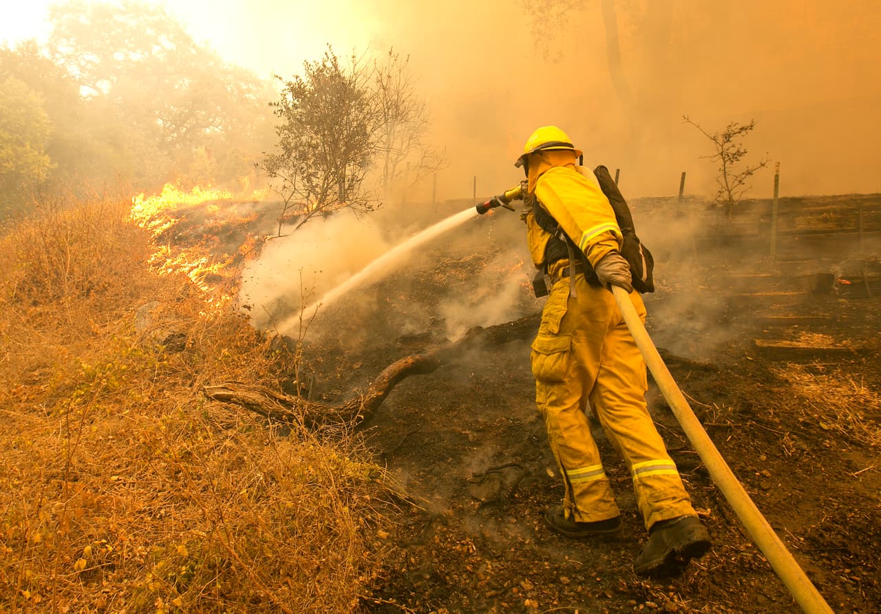 Un bombero lucha contra las llamas en el condado de Napa, al norte de San Francisco. Al menos 
<b>17 muertos y centenares de lesionados</b> han dejado a su paso los feroces incendios que azotan el norte de California.