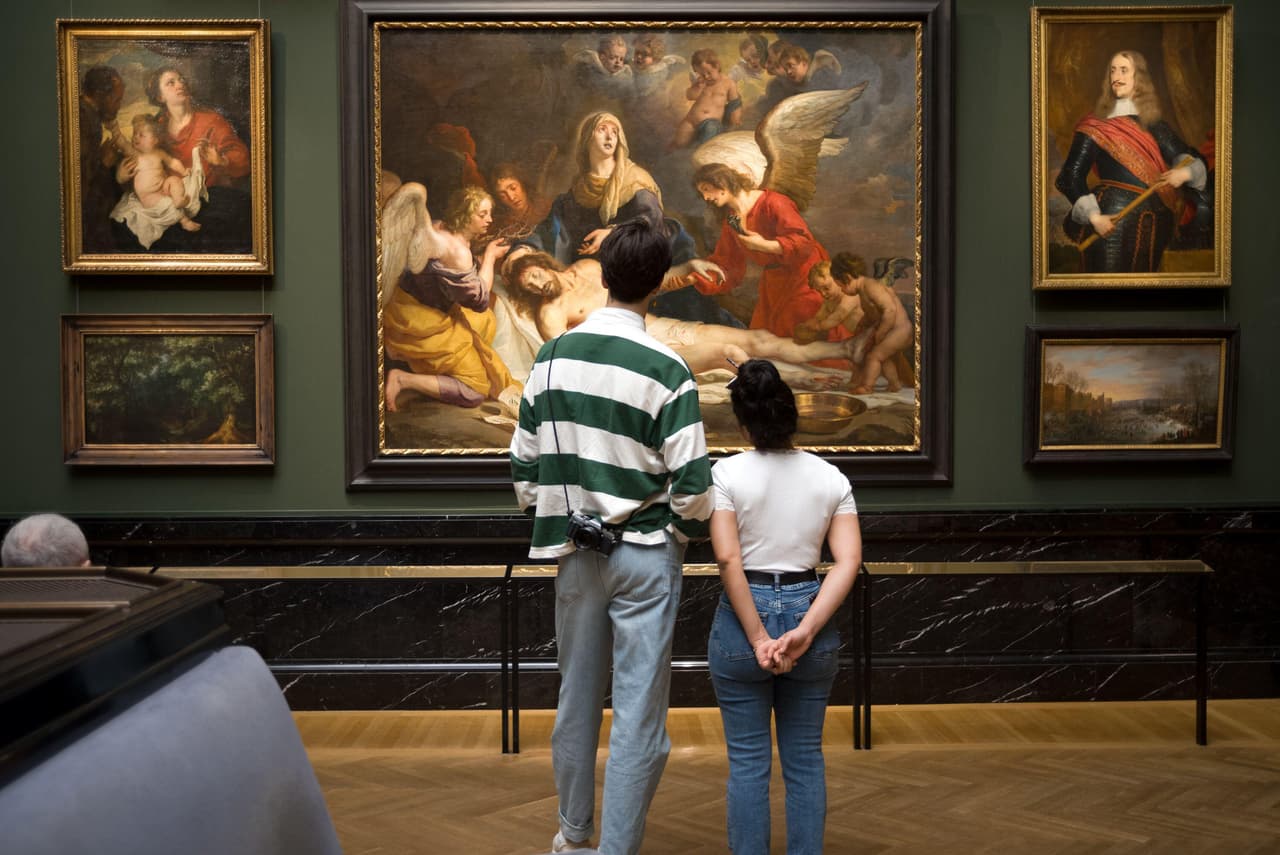 Young couple looking at painting in the museum