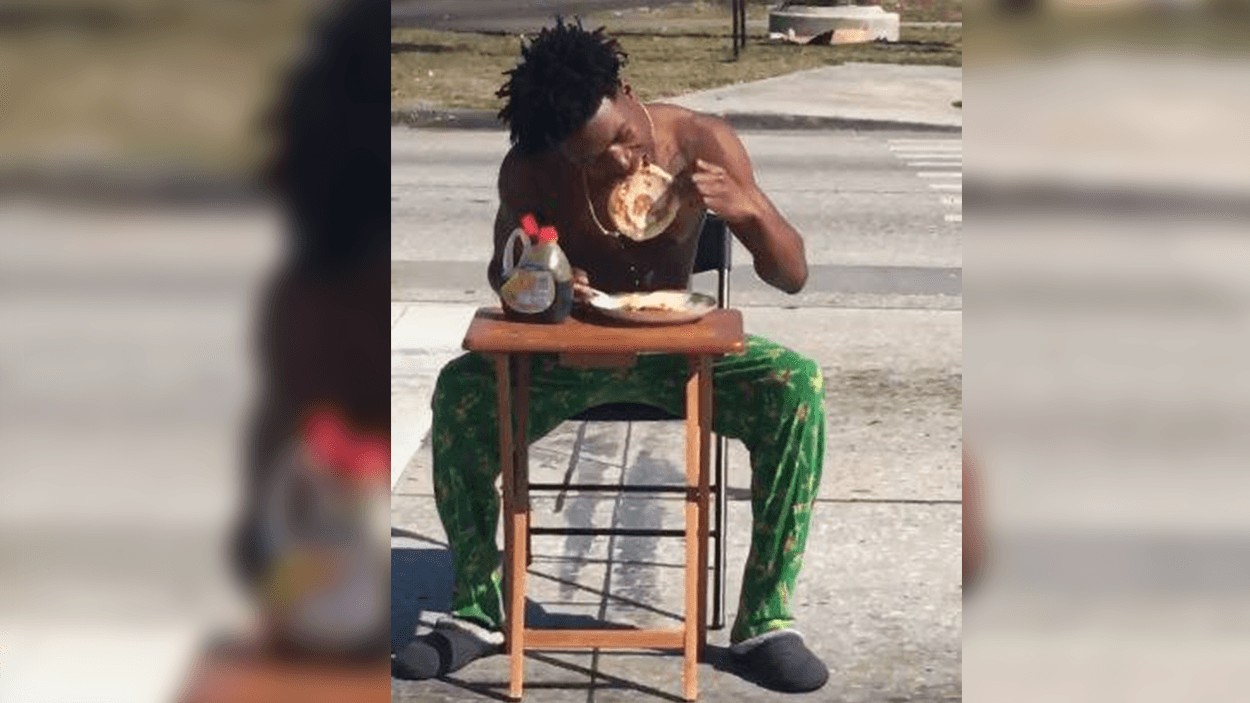 Man Enjoys Breakfast in the Middle of the Street