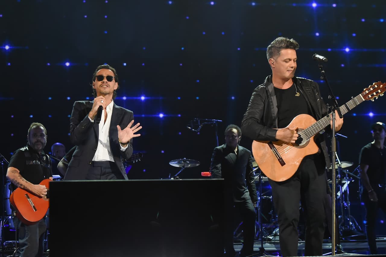 MIAMI, FL - OCTOBER 14: In this handout photo provided by One Voice: Somos Live!, Marc Anthony and Alejandro Sanz perform onstage at One Voice: Somos Live! A Concert For Disaster Relief at Marlins Park on October 14, 2017 in Miami, Florida. (Photo by Rick Diamond/One Voice: Somos Live!/Getty Images)