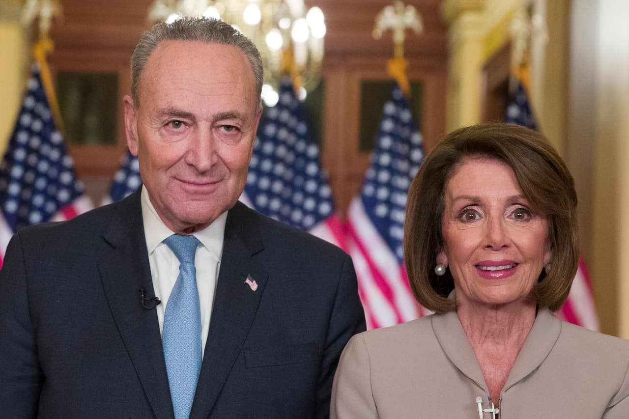 Senate Minority Leader Chuck Schumer of N.Y., and House Speaker Nancy Pelosi of Calif., pose for photographers after speaking on Capitol Hill in response President Donald Trump's address, Tuesday, Jan. 8, 2019, in Washington. (AP Photo/Alex Brandon)