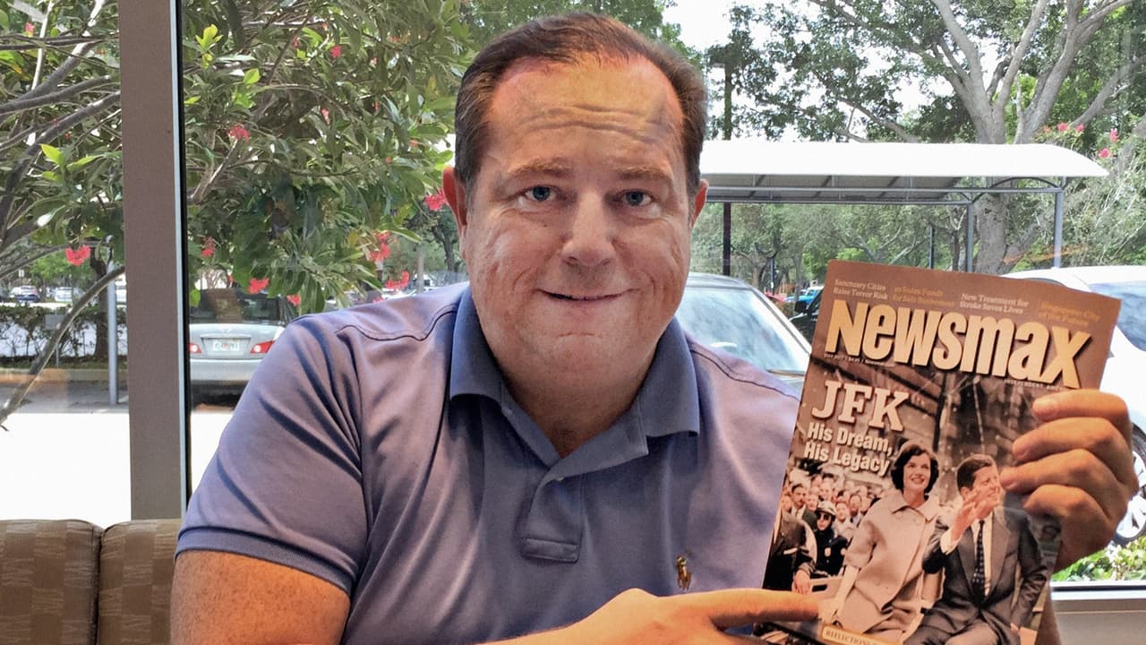 Christopher Ruddy with a copy of Newsmax magazine featuring the legacy of JFK. Photo taken at Newsmax office in Boca Raton May 31, 2017.