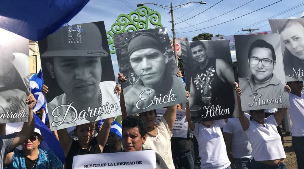 Protesters in Managua, Nicaragua hold images of fellow students killed in anti-government demonstrations during a march on April 23, 2018.