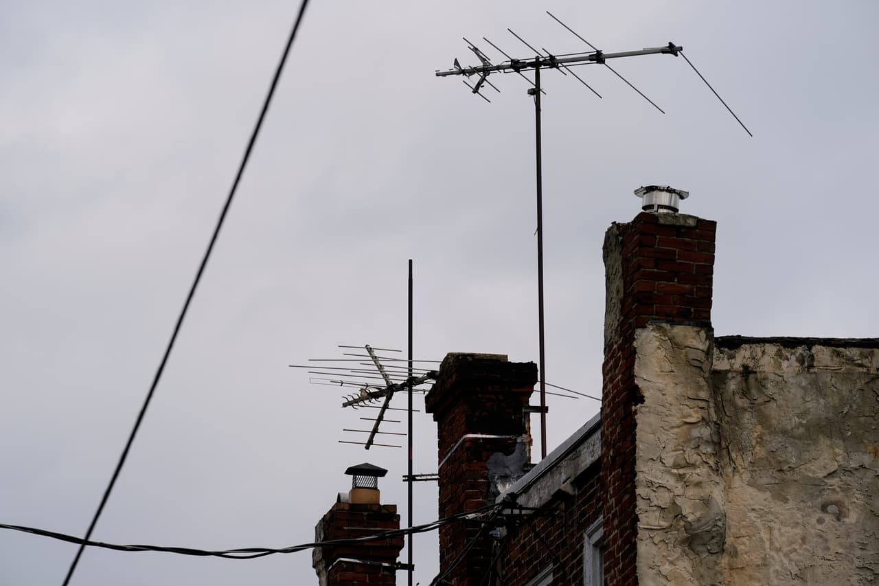 Analog television antennas on row homes in Philadelphia, Friday, March 26, 2021. (AP Photo/Matt Rourke)