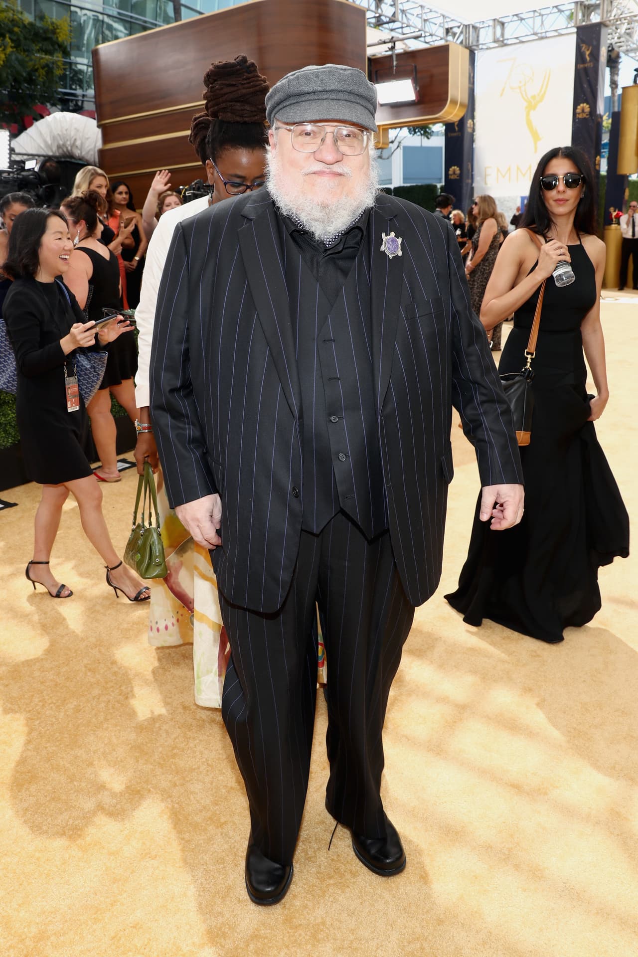 George R. R. Martin, escritor y creador de ¡game Of Thrones', desfiló con un traje a rayas y su ya insuperable gorra.
<br>