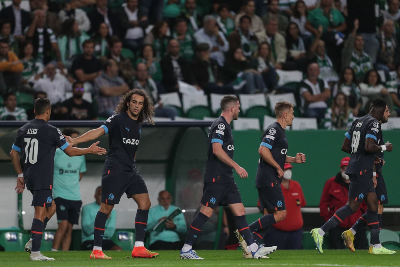 Marseille's French midfielder Matteo Guendouzi (2nd-L) celebrates with teammates after scoring his team's first goal during the UEFA Champions League 1st round, group D, football match between Sporting CP and Olympique de Marseille at the Jose Alvalade stadium in Lisbon on October 12, 2022. (Photo by CARLOS COSTA / AFP) (Photo by CARLOS COSTA/AFP via Getty Images)