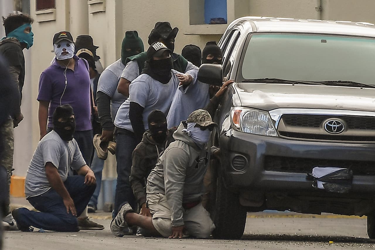 Paramilitaries surround the San Sebastian Basilica, in Diriamba, Nicaragua on July 09, 2018. - Armed supporters of the government of Nicaraguan President Daniel Ortega burst into the basilica, besieged and insulted bishops who had earlier arrived in Diriamba. (Photo by MARVIN RECINOS / AFP) (Photo credit should read MARVIN RECINOS/AFP/Getty Images)