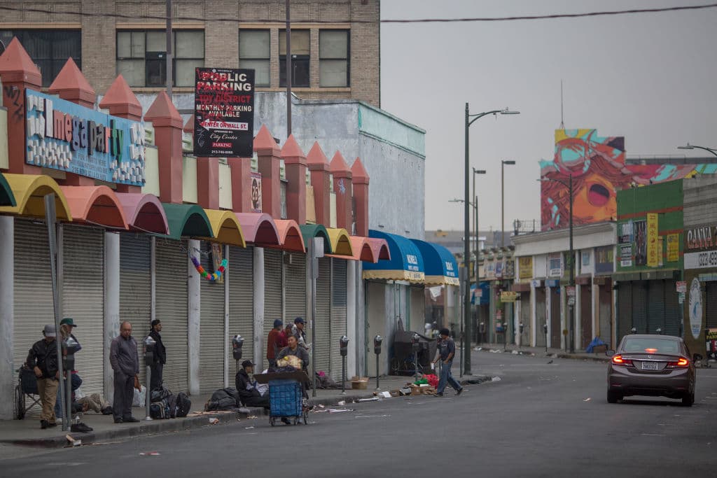 LOS ANGELES, CA - JUNE 01: Homeless people mill around on a Skid Row sidewalk after packing up their tents for the day and before businesses open on May 1, 2017 in Los Angeles, California. The newly released 2017 Greater Los Angeles Homeless Count indicates a 20 percent jump in the city of Los Angeles while Los Angeles County has spiked 23 percent. Voters have approved a record number of funds for homeless services with the passage of Measure HHH in the city and Measure H countywide. (Photo by David McNew/Getty Images)