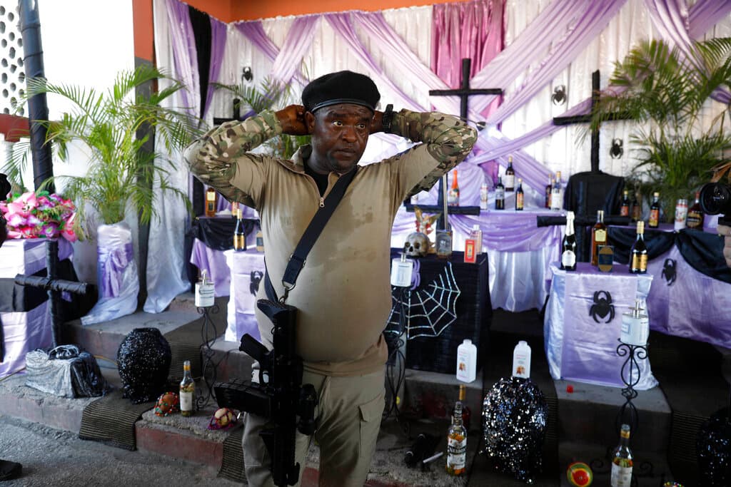 Jimmy Cherizier, alias 'Barbecue', the leader of the 
<i>G9 and Family</i> gang, stands in front of a public, street Vodou altar after giving a press conference in La Saline neighborhood of Port-au-Prince, Haiti, Wednesday. Nov 3, 2021.