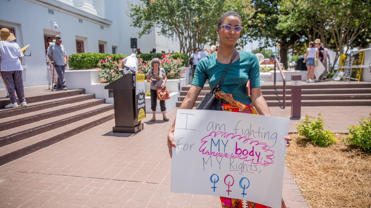 "I am fighting for my body, my rights,” reads another poster.