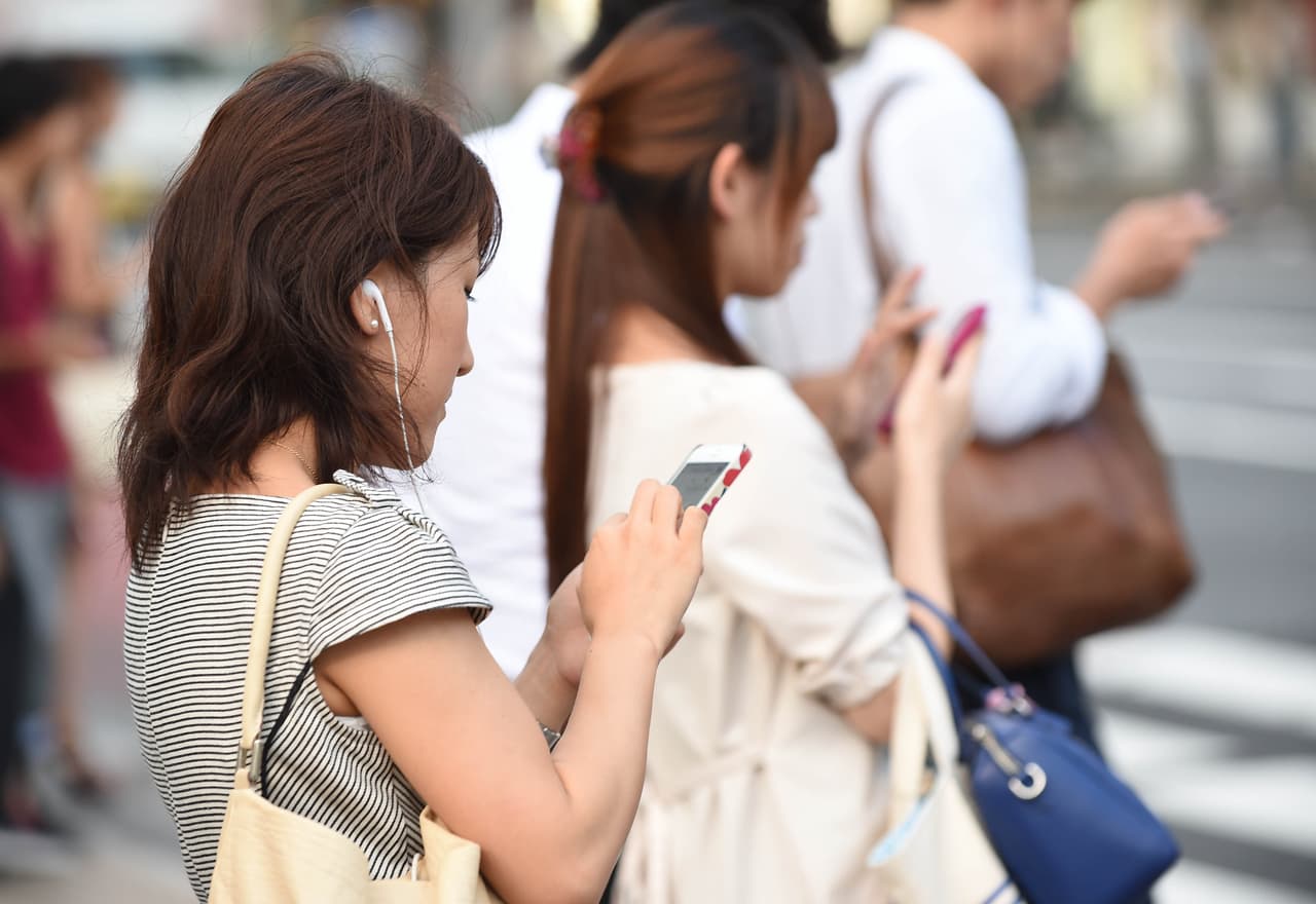 TOKYO, JAPAN - JULY 16: People use their smartphones on July 16, 2014 in Tokyo, Japan. Only 53.5% of Japanese owned smartphones in March, according to a white paper released by the Ministry of Communications on July 15, 2014. The survey of a thousand participants each from Japan, the U.S., Britain, France, South Korea and Singapore, demonstrated that Japan had the fewest rate of the six; Singapore had the highest at 93.1%, followed by South Korea at 88.7%, UK at 80%, and France at 71.6%, and U.S. at 69.6% in the U.S. On the other hand, Japan had the highest percentage of regular mobile phone owners with 28.7%. (Photo by Atsushi Tomura/Getty Images)