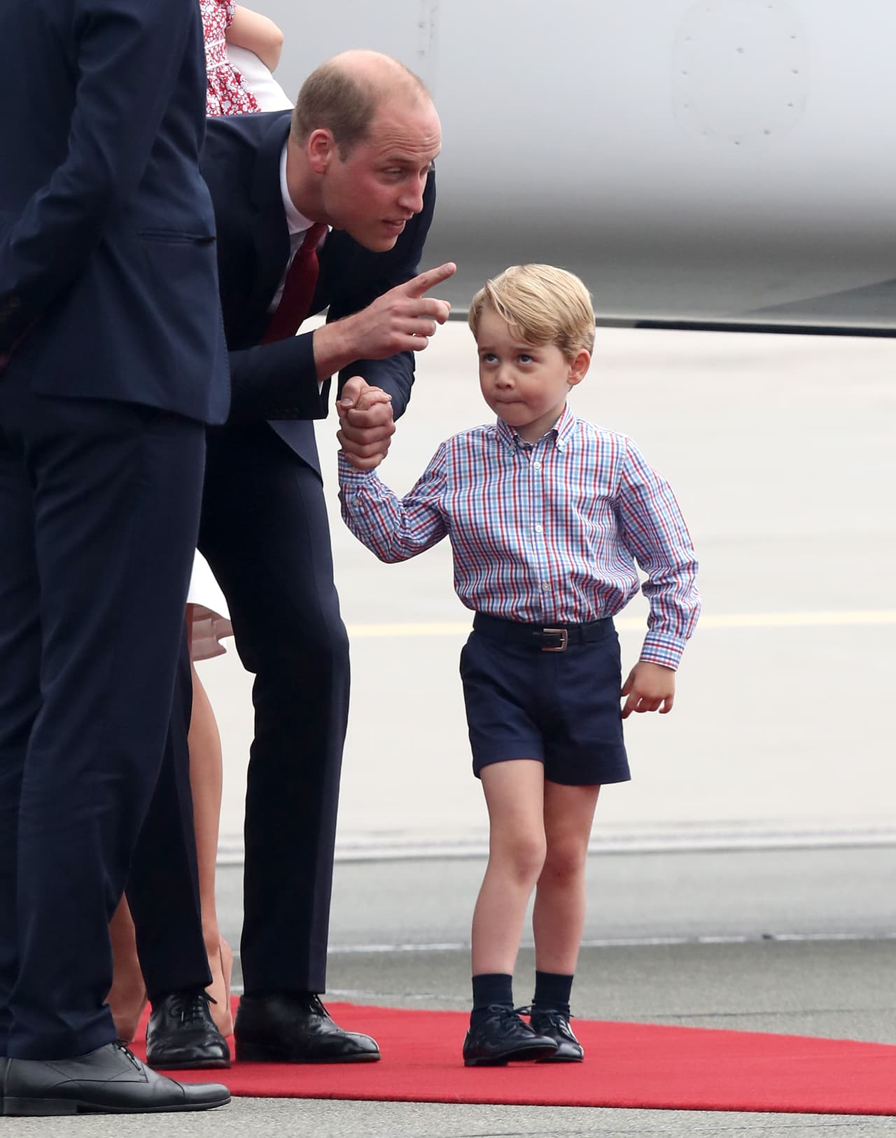 WARSAW, POLAND - JULY 17: Prince William, Duke of Cambridge speaks with Prince George of Cambridge as they arrive with Catherine, Duchess of Cambridge and Princess Charlotte of Cambridge on day 1 of their offical visit to Poland on July 17, 2017 in Warsaw, Poland. (Photo by Chris Jackson/Getty Images)